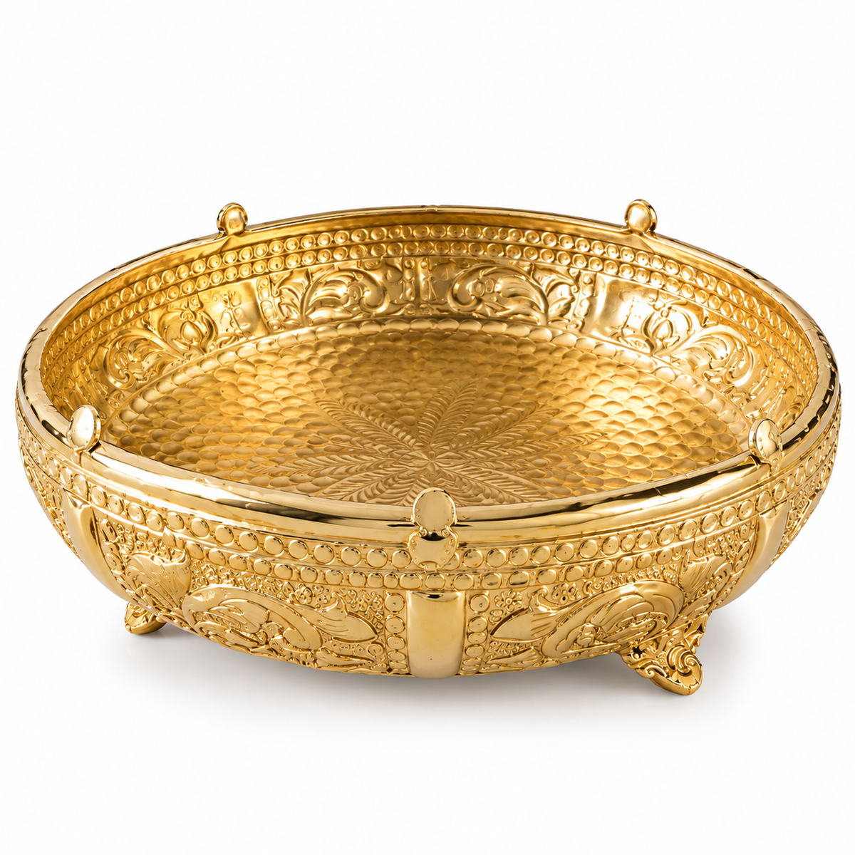 A decorative gold-plated metal bowl with intricate embossed floral patterns and small feet, shown on a clean white background.